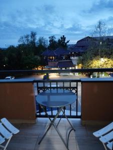 a table and chairs on a balcony at night at Sofija in Veliko Gradište