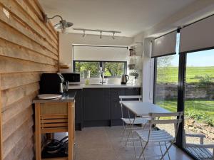 a kitchen and dining area with a table and chairs at Hedges House in Buckingham +17 photos