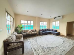 a large living room with couches and a rug at thedesert08 in Ras al Khaimah