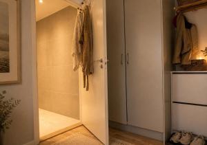 a bathroom with a walk in shower next to a door at Modern lägenhet i Vasastan in Stockholm
