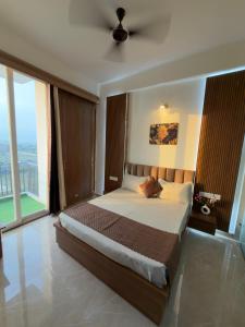 a bedroom with a large bed and a large window at The Orion Nest in Noida