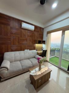 a living room with a couch and a table at The Orion Nest in Noida
