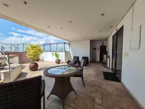 a living room with a table and chairs on a balcony at Apartment 13 - Jundiaí in Jundiaí