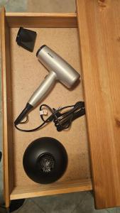 a wooden drawer with a hairdryer at LUCIA s sweet Home in Padova