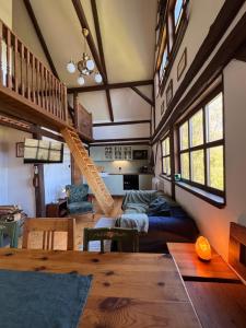 a living room with a staircase in a tiny house at Chalupa Pod Skalou Relax in Paseky nad Jizerou