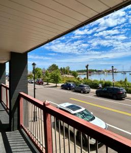 a balcony with a car parked on the street at The Harbor Inn in Grand Marais