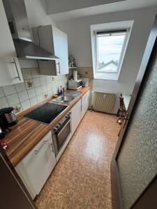 a small kitchen with a sink and a window at W&P Living Zi 5 Bräustüble FeWo 1 2OG l in Buttenwiesen