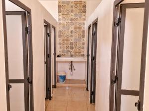 a hallway of a bathroom with a tub and a toilet at Taragalte Park - Motorhomes in Zagora