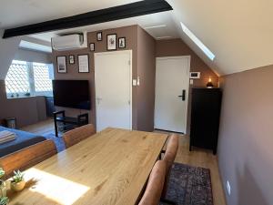 a living room with a wooden table and a couch at D10 Apartments in Breda