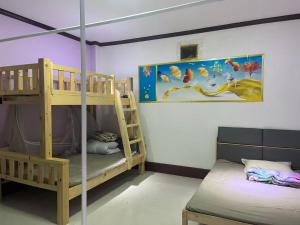 a room with two bunk beds and a bed at FUBON World Guesthouse in Ban Nongpapao
