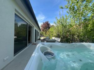 a hot tub in the backyard of a house at Fészek Villa in Balatonszemes