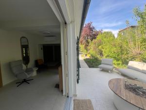 an open door to a patio with chairs and a table at Fészek Villa in Balatonszemes