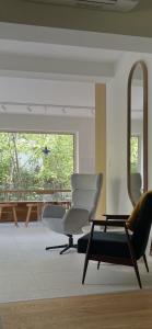 a living room with two chairs and a table and a mirror at Fészek Villa in Balatonszemes