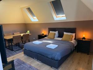 a bedroom with a bed and a table with a desk at D10 Apartments in Breda