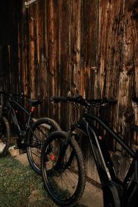two bikes parked next to a wooden wall at Mala kuća in Vele Drage