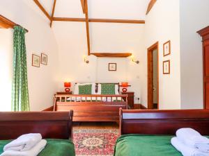 a bedroom with two beds and a crib at East Bickleigh in Totnes +47 photos