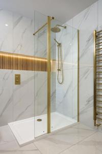 a shower with a glass door in a bathroom at Blythswood Square Apartments in Glasgow +136 photos