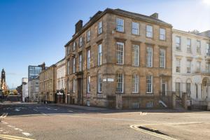 an old brick building on the corner of a street at Blythswood Square Apartments in Glasgow