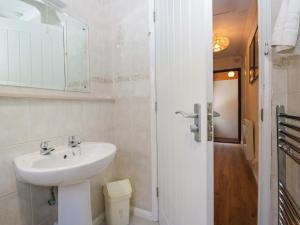 a bathroom with a sink and a mirror at Beech Timber Lodge in Keswick +69 photos
