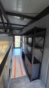 a room with bunk beds in a trailer at Hangar Hangout by the Lake in Priles +18 photos