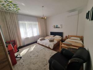 a living room with two beds and a couch at Artisan Center Apartment Peja in Peje