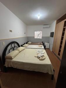 a bedroom with two beds with towels on them at Jampa Pousada Sb in João Pessoa