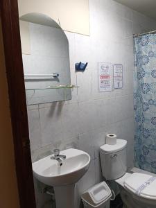 a small bathroom with a sink and a toilet at HOTEL San Antonio in Puno