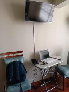 a laptop computer sitting on a table with a chair at HOTEL San Antonio in Puno +15 photos