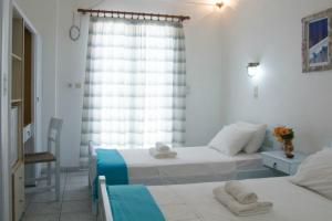 Postel nebo postele na pokoji v ubytování Hotel Faros