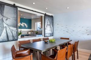 a dining room with a table and chairs at The Inn Above Tide in Sausalito