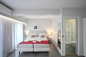 a bedroom with a large bed and a bathroom at My Charm Lisbon Suites in Lisbon