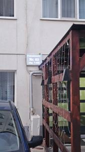 a street sign on the side of a building at Modern Family Apartment, Free Parking, Balcony, Sleeps 5 in Bucharest