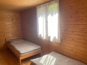 a small room with a bed and a window at Chata Čertovy hlavy in Želízy +3 photos