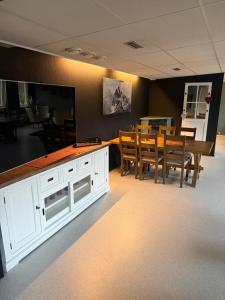 a kitchen and dining room with a table and chairs at Harran Gjestehus in Harran