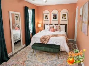 a bedroom with a bed with pink walls and mirrors at luxury condo, pet friendly, close to everything in Augusta