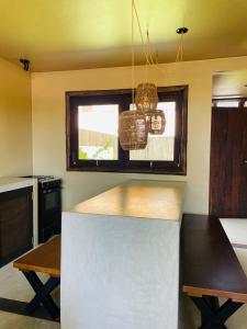 a kitchen with a white counter top and a window at Villa Coco e Sol - Casa com Jacuzzi in Amontada