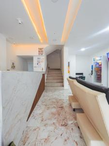 a lobby with a marble counter and stairs at Hotel Perla Dorada in San Miguel