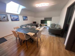 a living room with a table and chairs and a couch at Victoria Prestige Parking Gratuit in Boussu