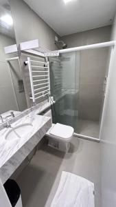 a bathroom with a toilet and a sink and a mirror at Pousada Aquarela Do Brasil in Maceió +17 photos