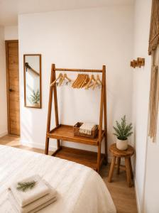 a bedroom with a bed and a shelf with shoes at La Marmotte appartement cosy centre Briancon proche Prorel in Briançon