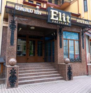 a hotel entrance with stairs in front of a building at Elit Garden Hotel in Kamianets-Podilskyi