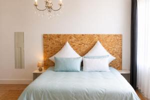 a bedroom with a white bed with two pillows at The Grace and Hope House in Bunkers Hill