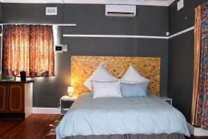 a bedroom with a large bed with white pillows at The Grace and Hope House in Bunkers Hill