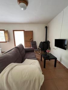 a living room with a couch and a table at Orgiva - La Alpujarra in Órgiva +10 photos