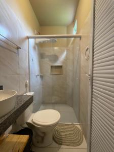 a bathroom with a shower with a toilet and a sink at Casa Dona Vilma in Barreirinhas +75 photos
