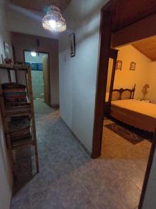 a room with a bedroom with a bed and a staircase at Ecoturismo Tripuí in Aiuruoca