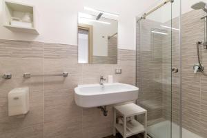 a bathroom with a sink and a glass shower at La Dimora del Passante in San Vito lo Capo +36 photos