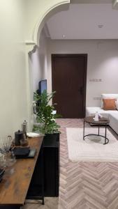 a living room with a table and a couch at شقة ذا لوكس لوفت 2 in Buraydah