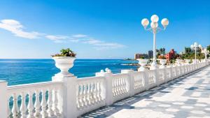 a white fence with a view of the ocean at Casa rody in Benalmádena