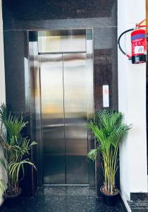 a stainless steel refrigerator in front of a building at S K Comforts in Bangalore